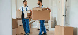 image of 2 movers carrying boxes and walking through a house