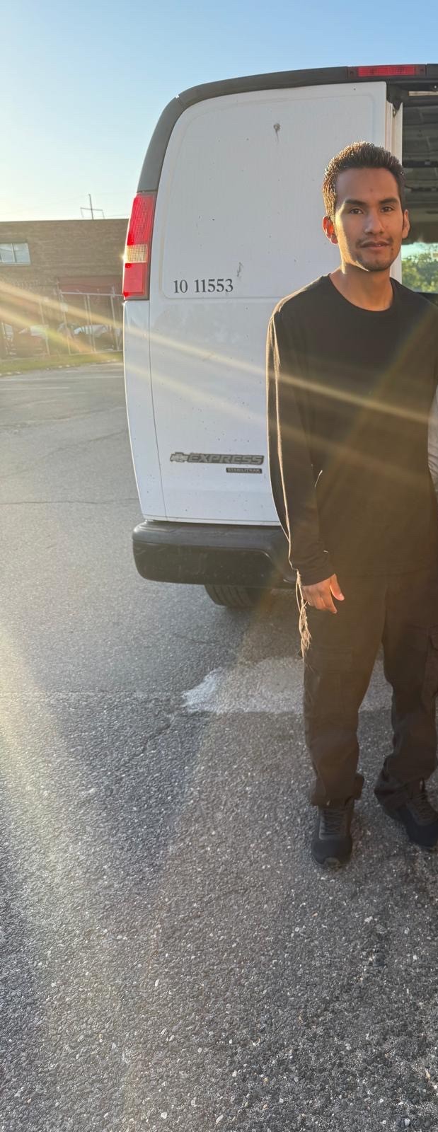 Residential House packing mover standing behind the van