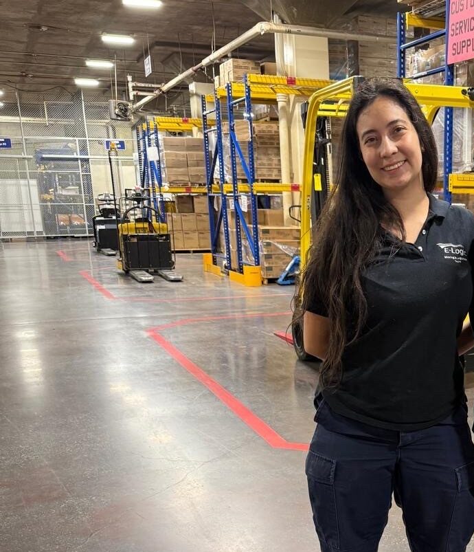 A gorgeous woman standing in a commercial storage facility