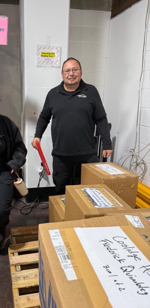 A man holding a tablet with an eye glasses wearing black jacket packaging for professional movers